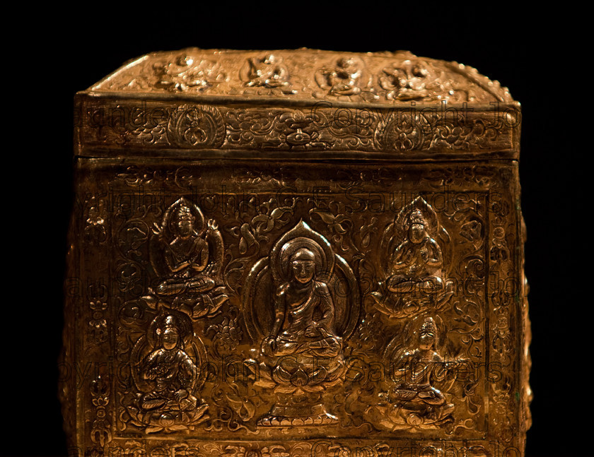 IMG 2781 
 Ancient Chinese gold treasure or funerary urn from the Tang dynasty (618 - 907CE), with intricate decorative side and lid showing seated emperor and buddhas. 
 Keywords: Tang, ancient, art, box, casket, chinese, cube, decorated, dynasy, gold, hand made, precious, shadows, shiny, square, treasure, urn