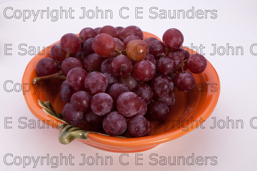 IMG 7806 
 Grapes in bowl 
 Keywords: grapes,red,fruit,bunch,bowl,food,healthy,isolated,white background