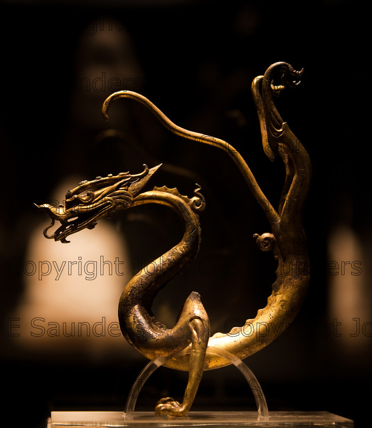 IMG 2764 
 Chinese Gold dragon sculpture from the Han dynasty (206BCE - 8CE) 
 Keywords: Qin, ancient, art, brown, chinese, culture, dark, dragon, dynasty, gold, history, sculpture, shadows, statue